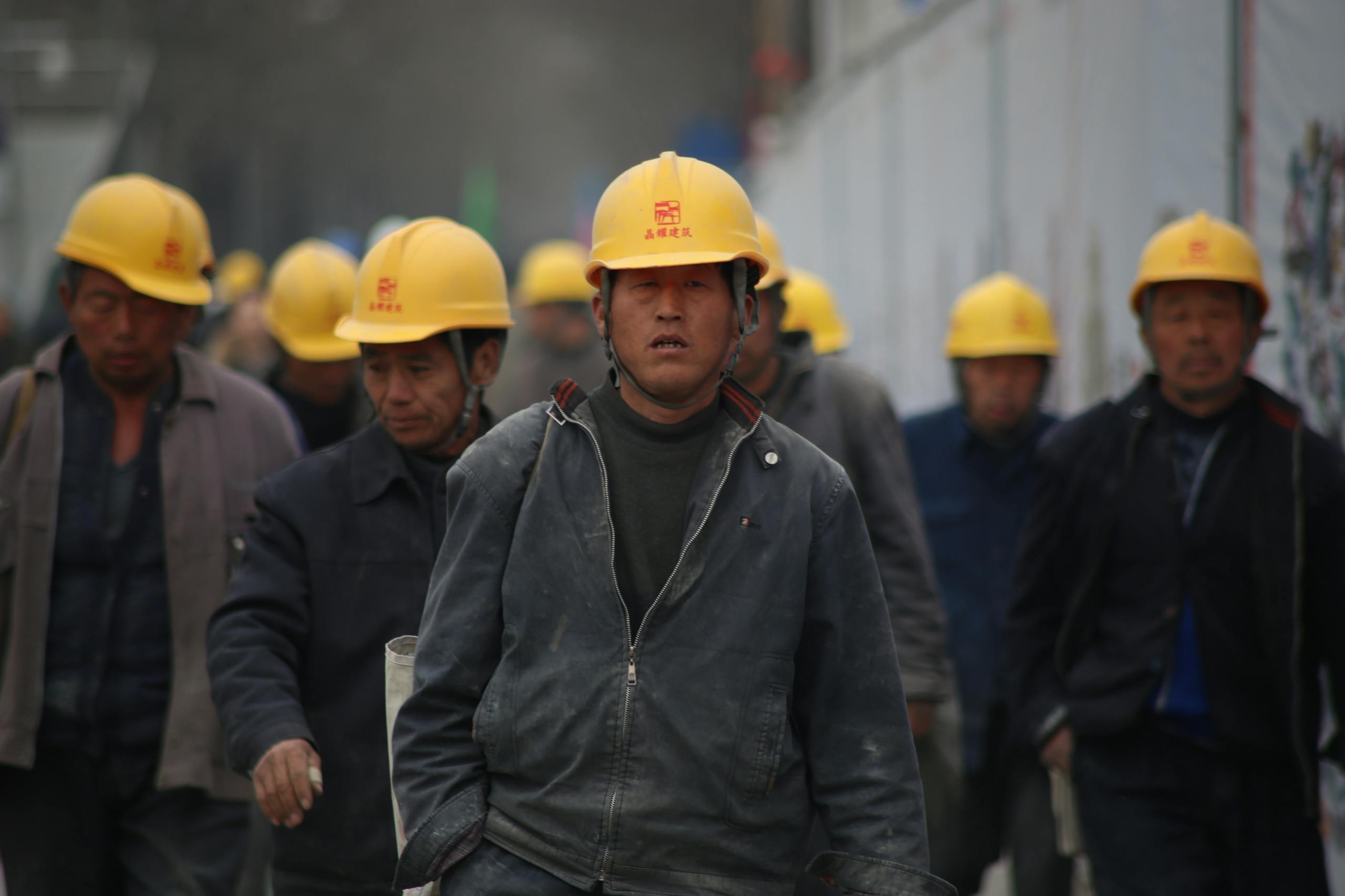 Group of Persons Wearing Yellow Safety Helmet during Daytime